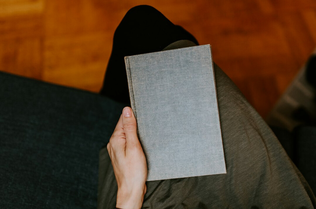 person reading book at home