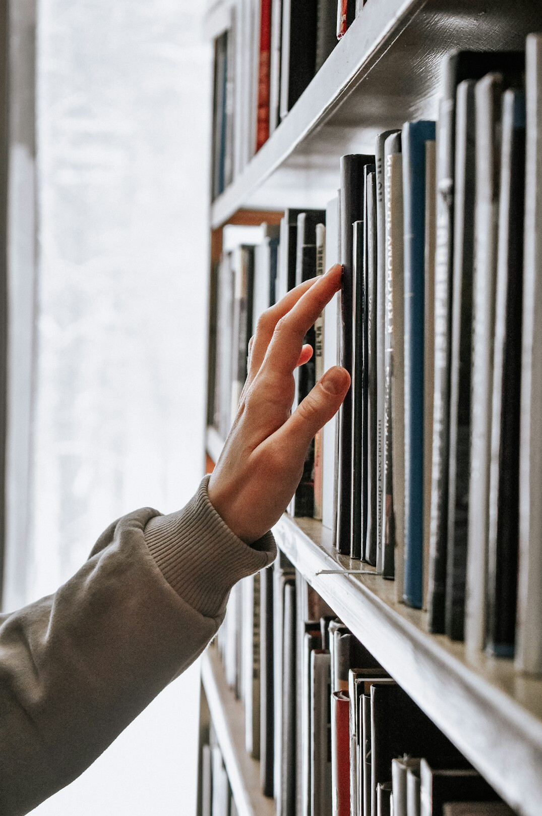 person reading book in library